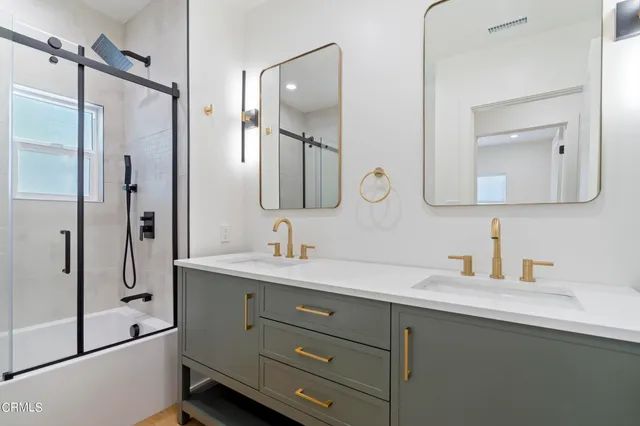 a bathroom with a double vanity sink mirror and double