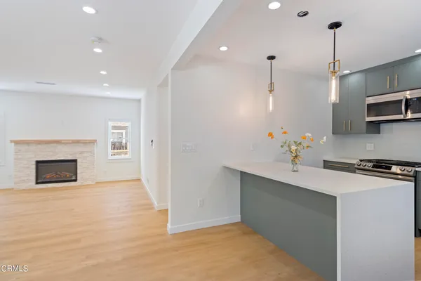 a kitchen with kitchen island a sink stainless steel appliances and cabinets