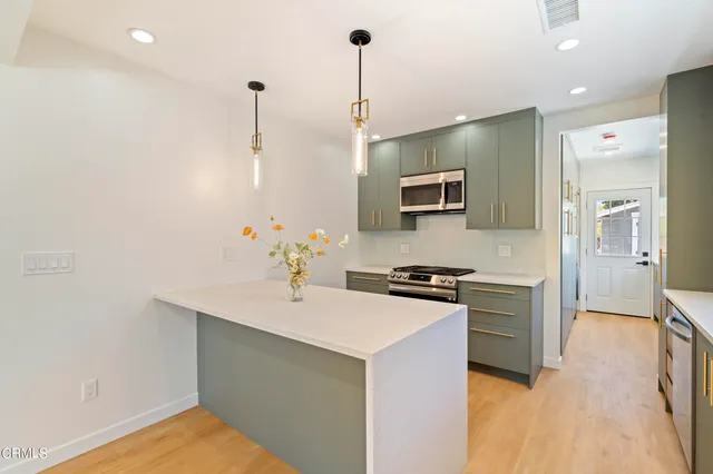 a kitchen with a sink stove and refrigerator
