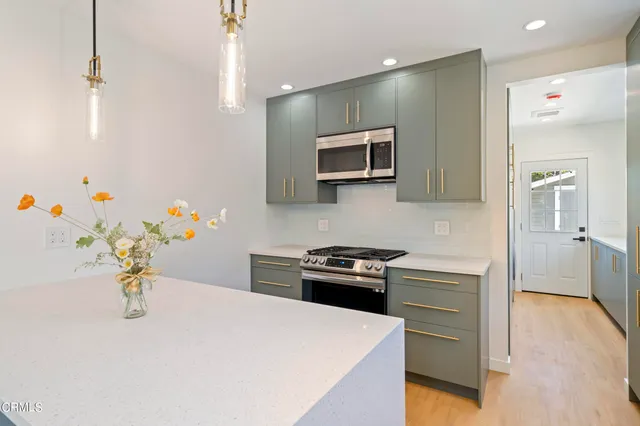 a kitchen with a sink a stove and microwave