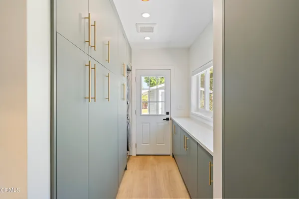 a view of a hallway with wooden floor and staircase
