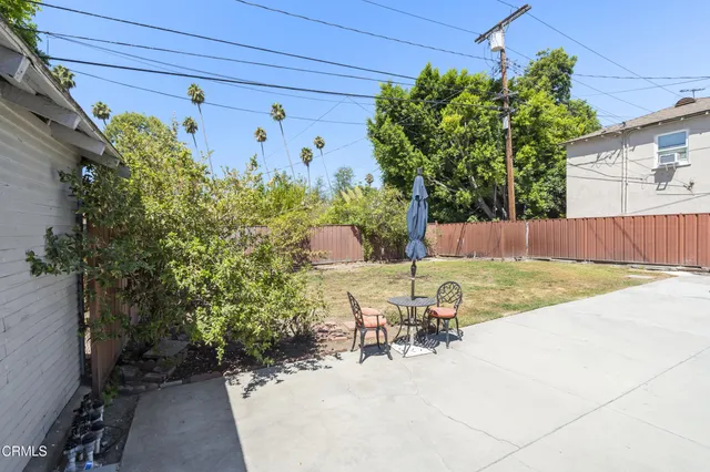 a view of a backyard with plants and a patio