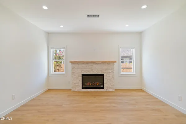 a view of empty room with a fireplace