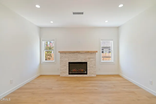a view of empty room with a fireplace