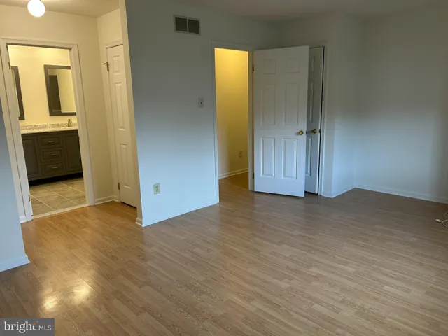 a view of hallway with wooden floor
