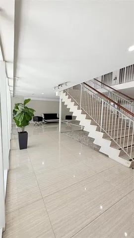 a view of a hallway with wooden floor and dining room