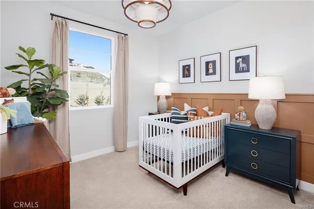 a bedroom with a bed and a potted plant