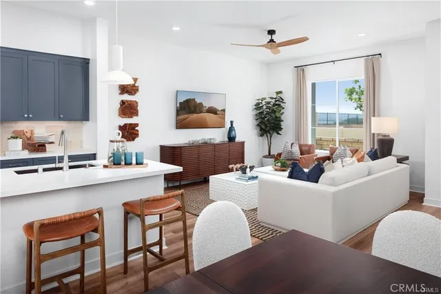 a living room with furniture a large window and a fireplace