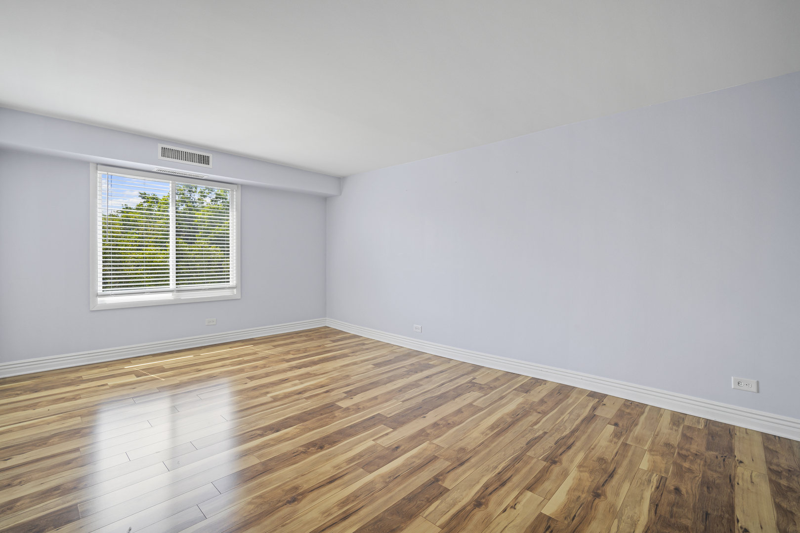 1615 East Central Road, Unit 417C Arlington Heights, IL 60005 - Photo 16 of 24 wooden floor in an empty room with a window