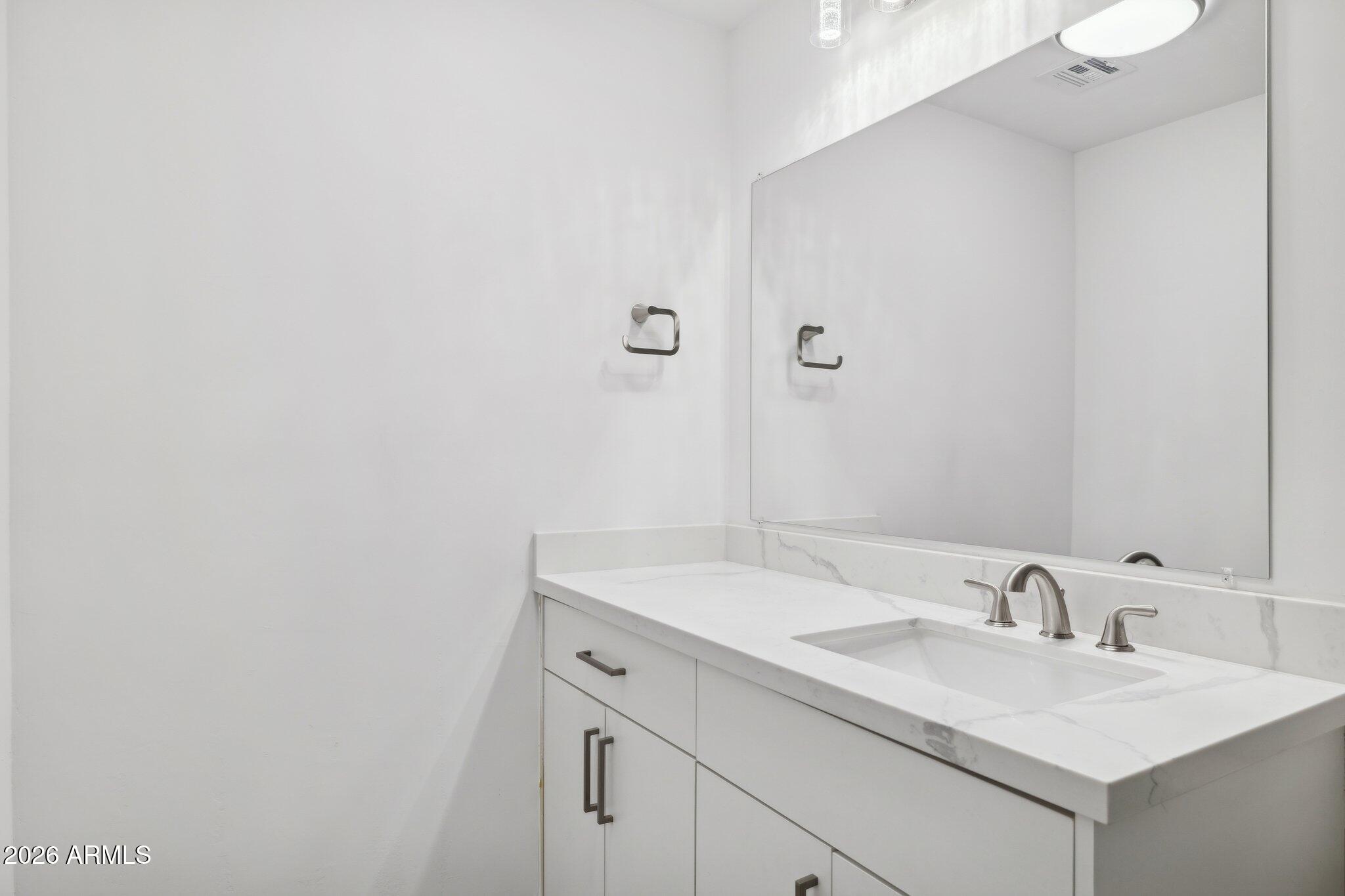 4144 North 36th Street Phoenix, AZ 85018 - Photo 13 of 30 a bathroom with a sink and a mirror