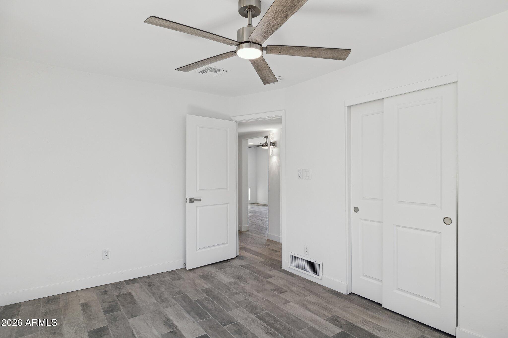 4144 North 36th Street Phoenix, AZ 85018 - Photo 17 of 30 a view of an empty room with wooden floor