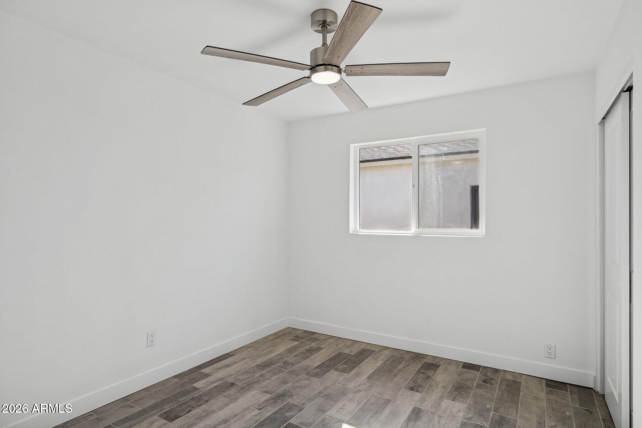 4144 North 36th Street Phoenix, AZ 85018 - Photo 21 of 30 an empty room with a window and a fan