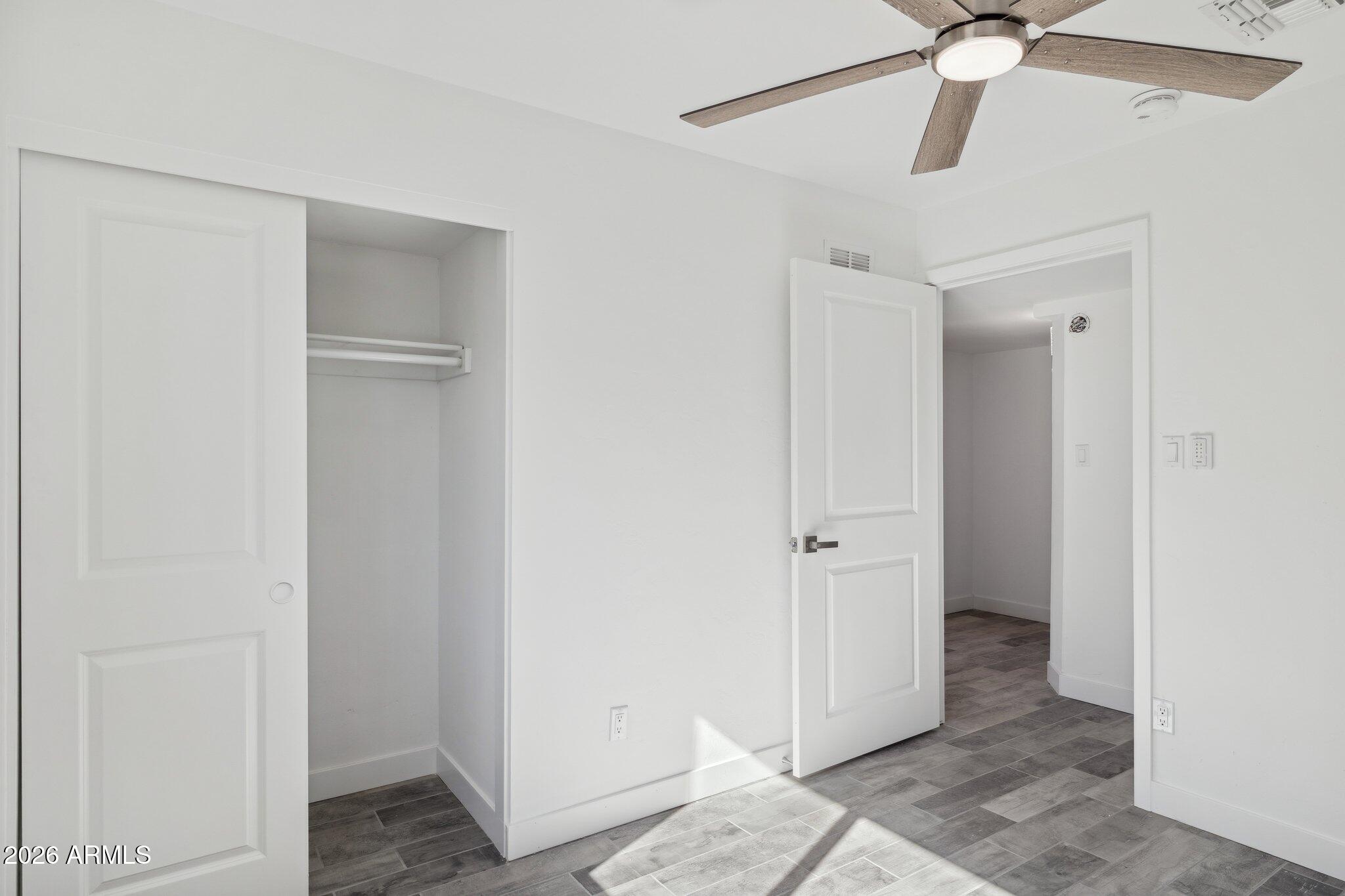 4144 North 36th Street Phoenix, AZ 85018 - Photo 22 of 30 a view of a hallway with a chandelier fan