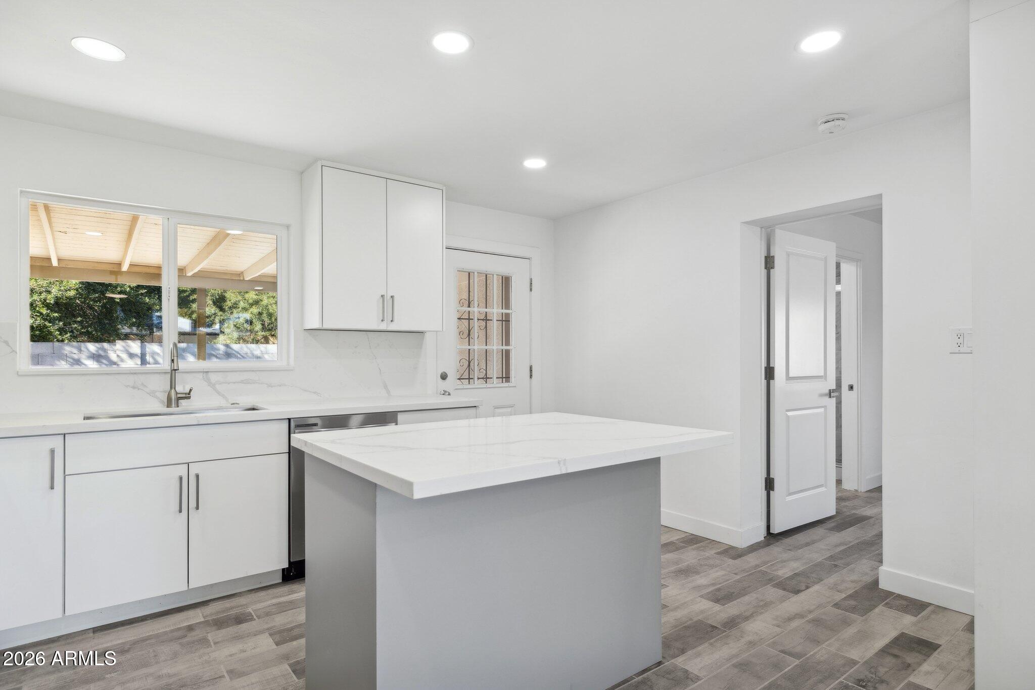4144 North 36th Street Phoenix, AZ 85018 - Photo 5 of 30 a kitchen with a sink stove and cabinets