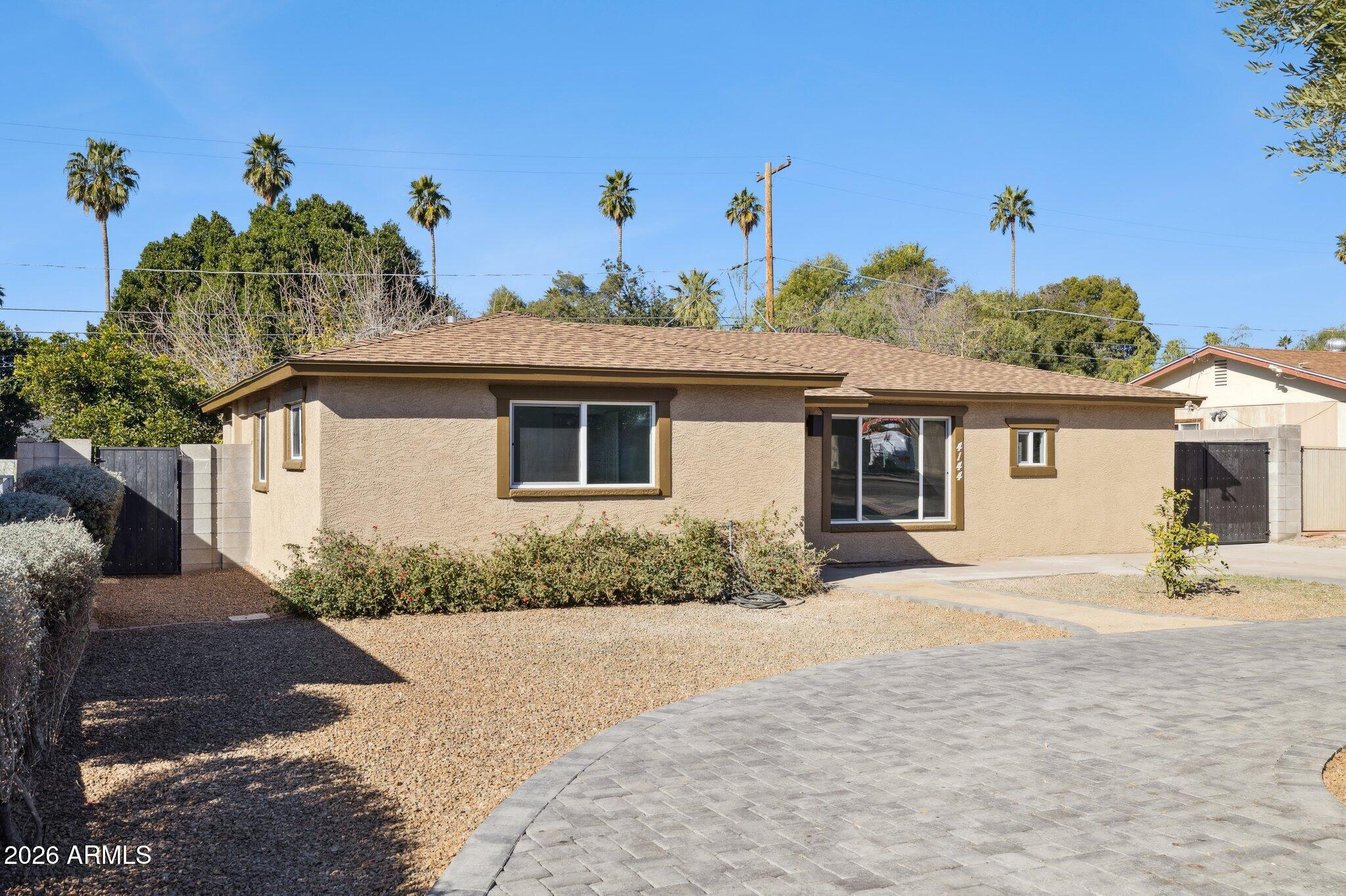 4144 North 36th Street Phoenix, AZ 85018 - Photo 7 of 30 a front view of a house with a yard
