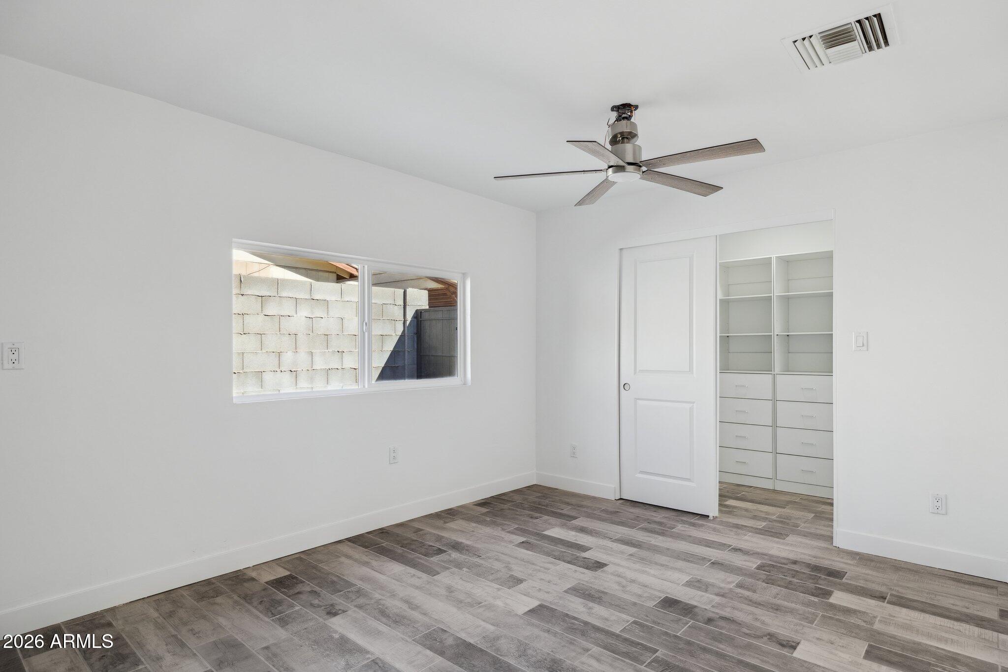 4144 North 36th Street Phoenix, AZ 85018 - Photo 10 of 30 an empty room with windows and fan