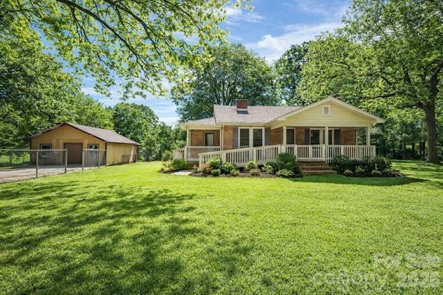 2041 Clyde Street Dallas, NC 28034 - Photo 1 of 46 a front view of a house with a yard and trees