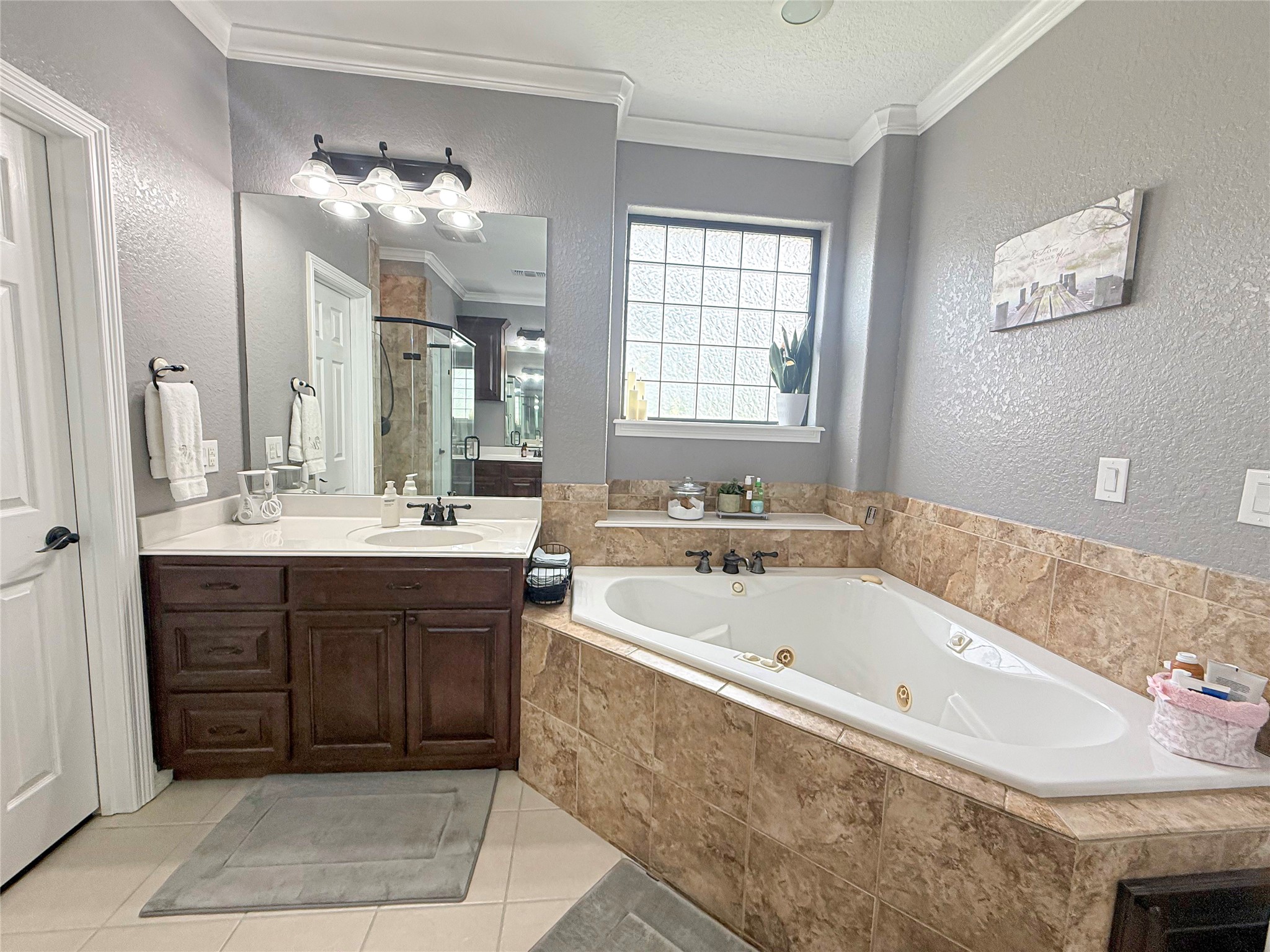 807 Mill Road Angleton, TX 77515 - Photo 26 of 46 Thoughtfully designed primary bathroom offers double vanities, ample space, and elegant finishes.