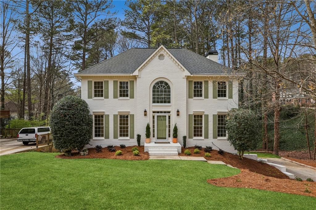 105 Inverness Approach Roswell, GA 30075 - Photo 2 of 51 a front view of a house with a garden