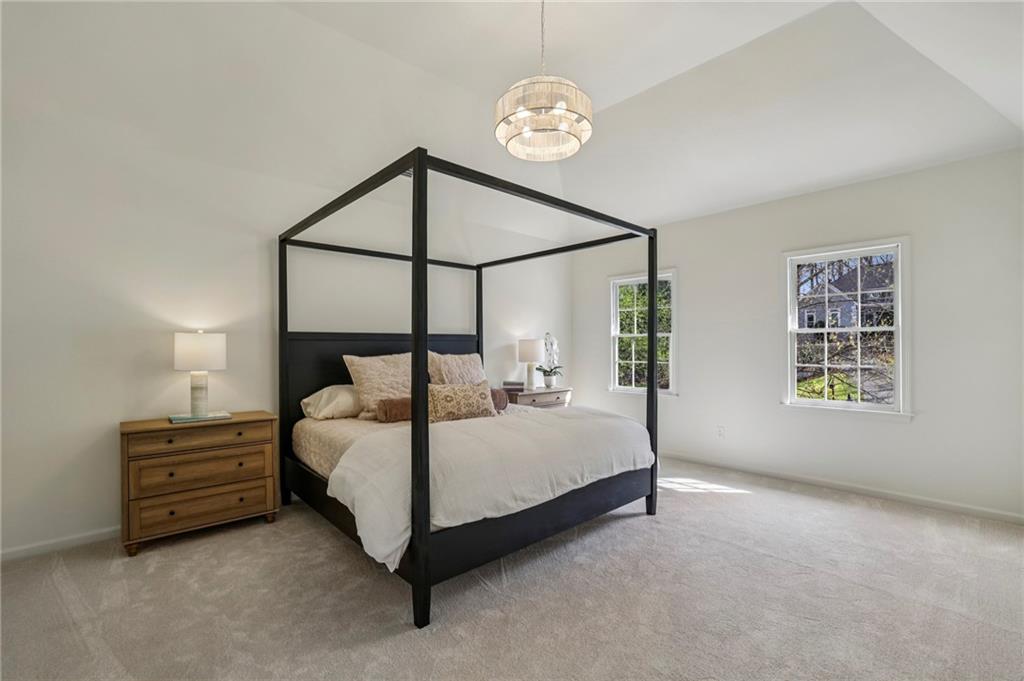 105 Inverness Approach Roswell, GA 30075 - Photo 24 of 51 a bed room with a bed and a chandelier