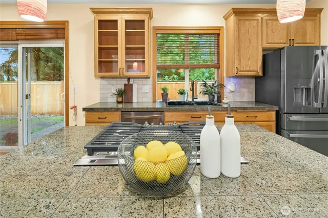 a kitchen with a refrigerator stove and wooden cabinets