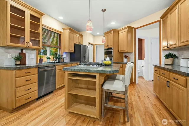 a dining room with furniture a chandelier and wooden floor