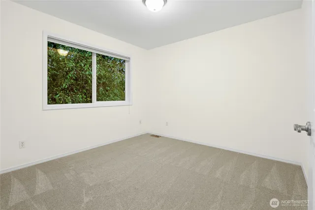 a bedroom with a large bed and a window