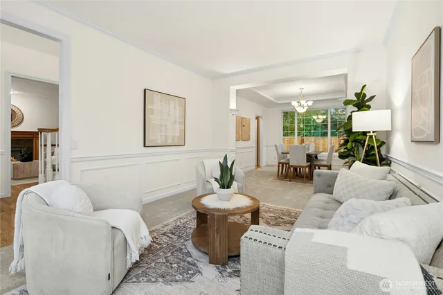 a living room with furniture a couch and a potted plant