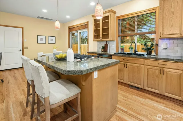 a kitchen with a sink cabinets and window