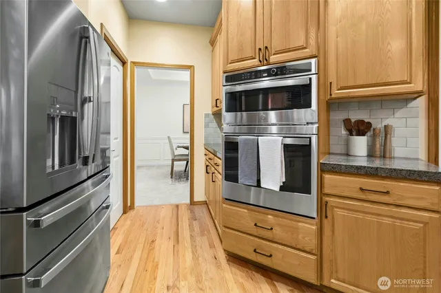 a kitchen with stainless steel appliances granite countertop a stove and a refrigerator