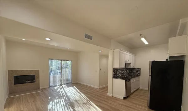 a kitchen with a refrigerator and a stove top oven
