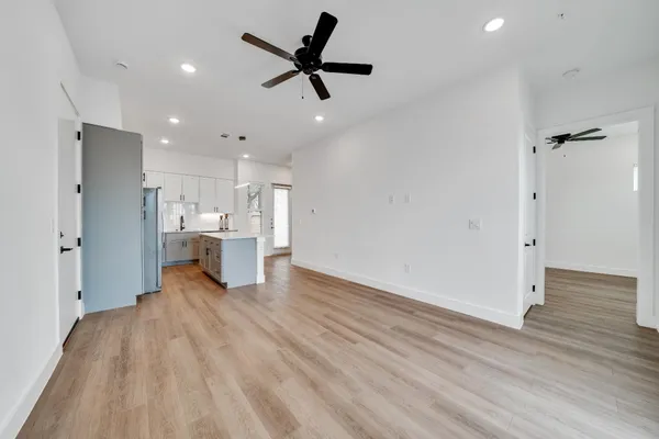 a view of a kitchen with wooden floor and a sink