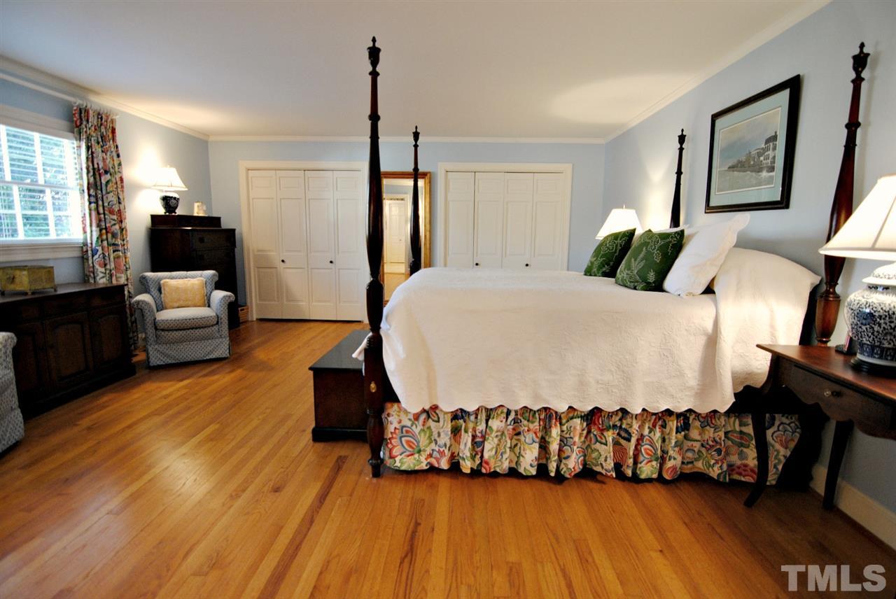 304 Foxhall Street Raleigh, NC 27609 - Photo 11 of 25 a bedroom with a bed and wooden floor