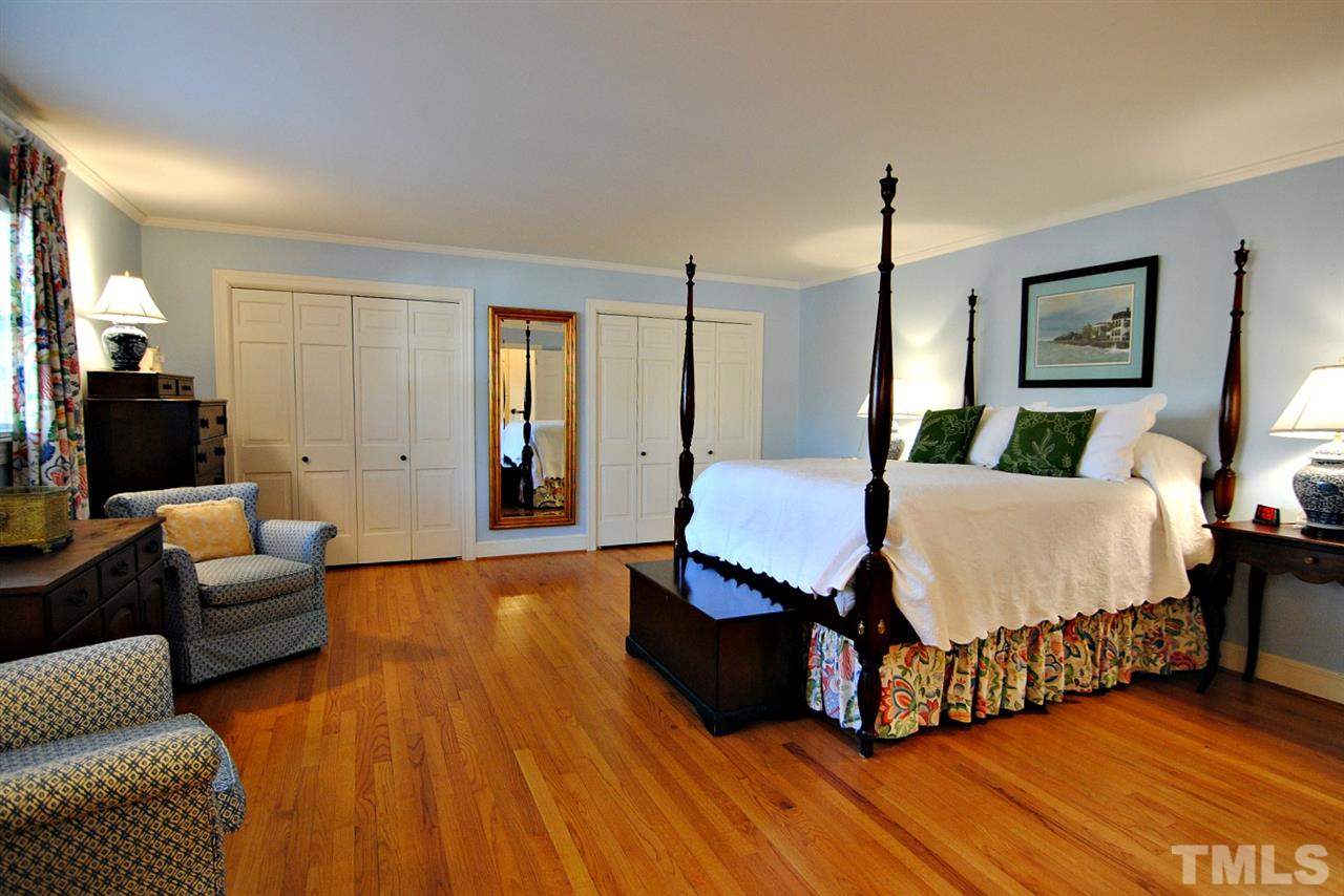 304 Foxhall Street Raleigh, NC 27609 - Photo 12 of 25 a spacious bedroom with a bed a couch and dresser