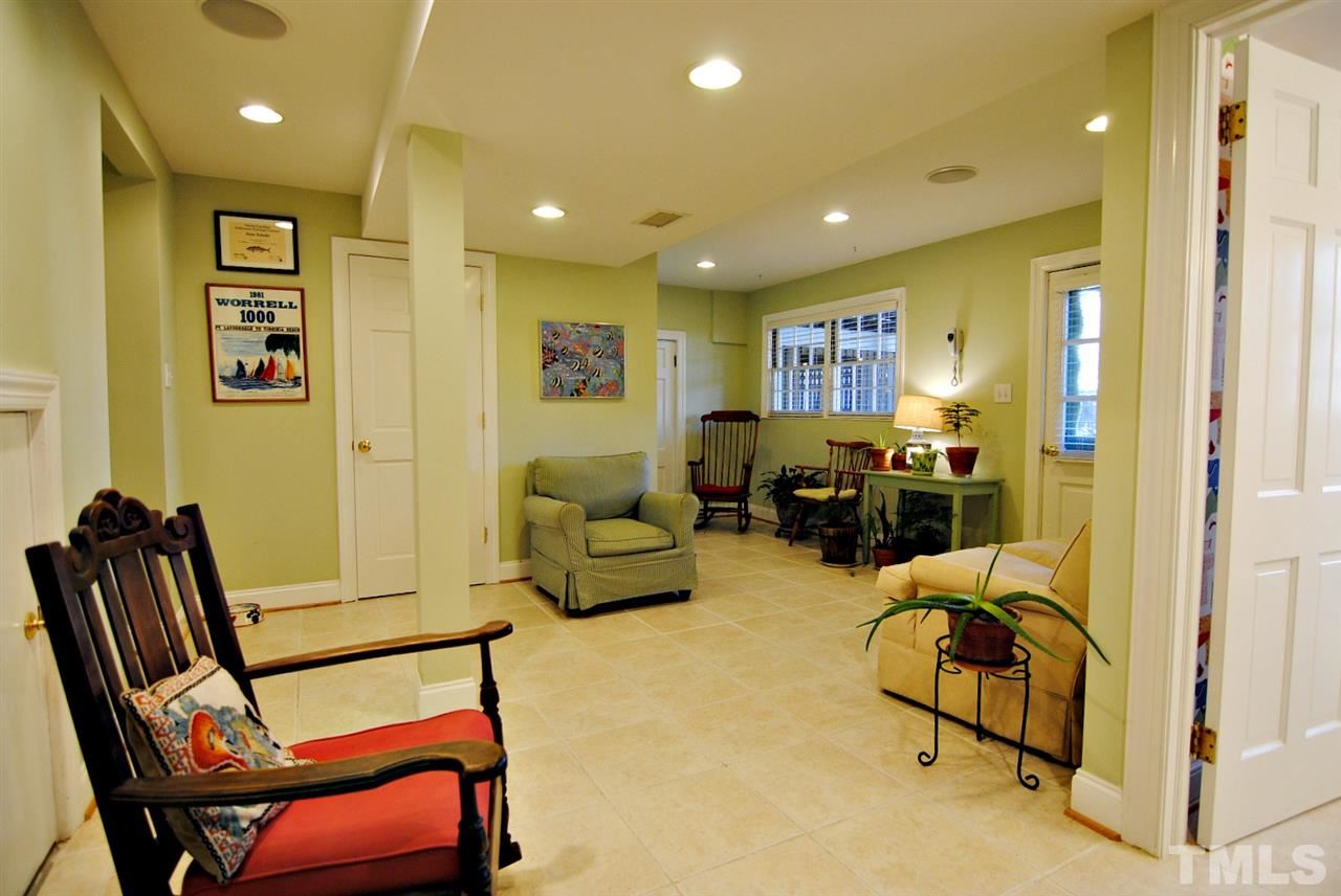 304 Foxhall Street Raleigh, NC 27609 - Photo 16 of 25 a living room with furniture gym equipment and a glass door