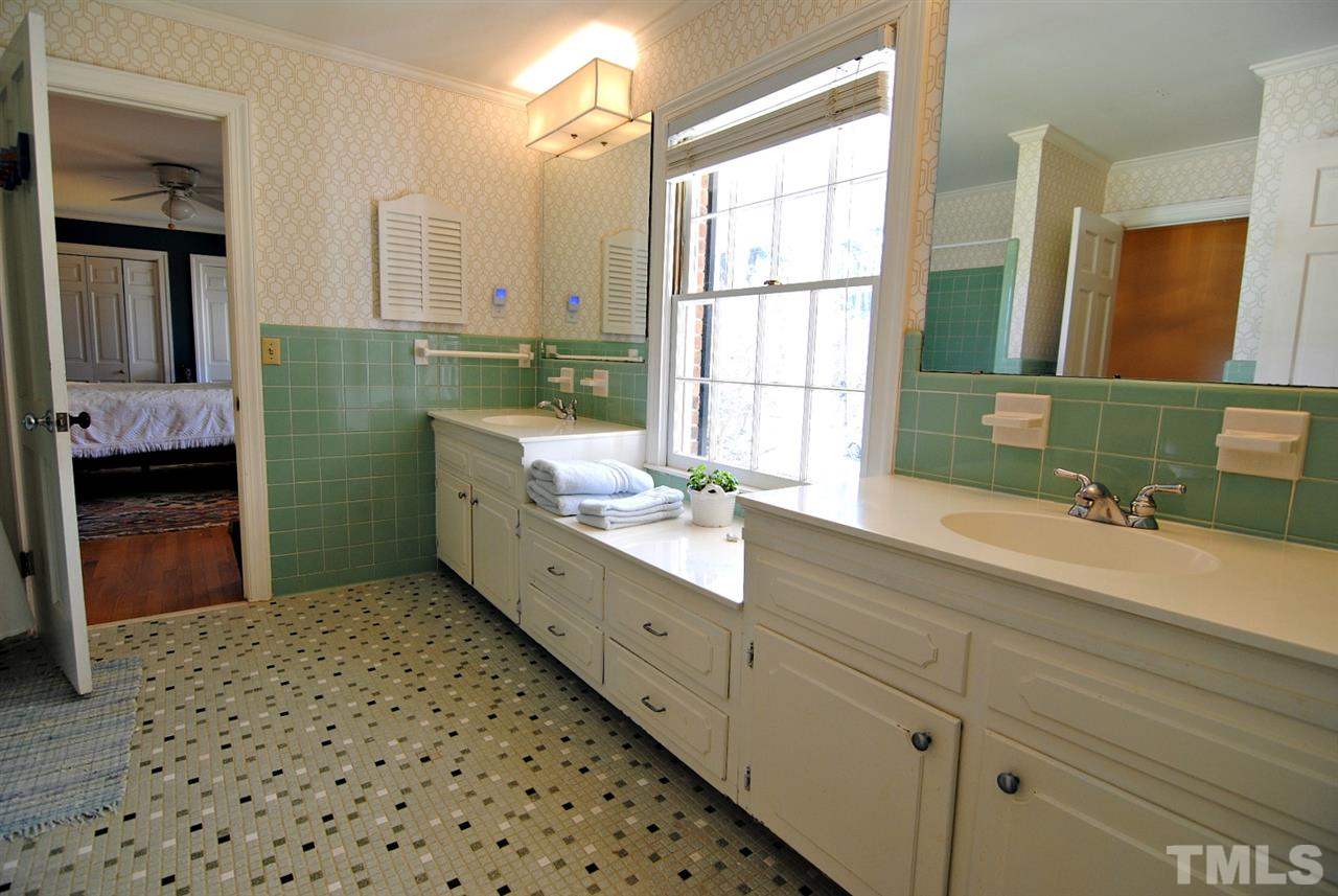 304 Foxhall Street Raleigh, NC 27609 - Photo 19 of 25 a bathroom with a double vanity sink mirror and bathtub