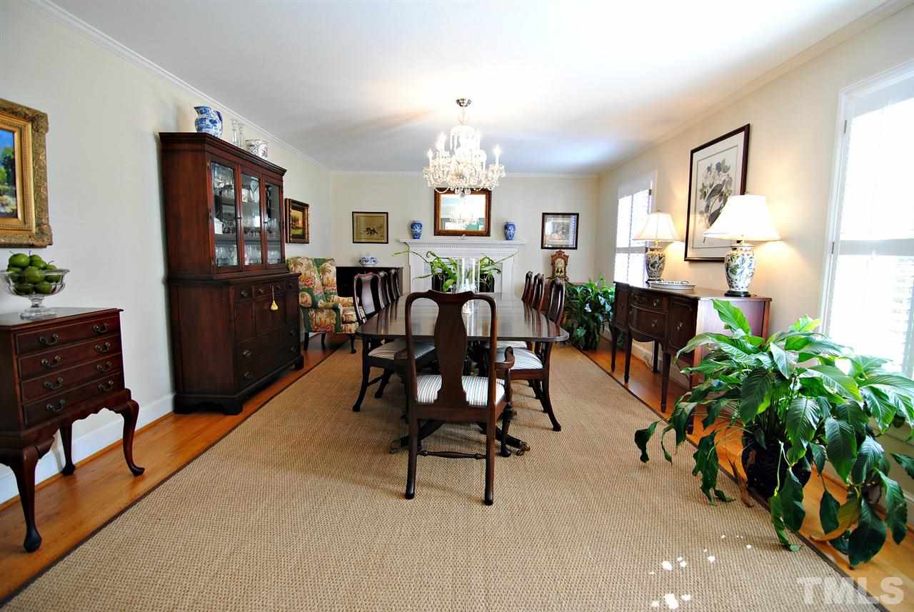 304 Foxhall Street Raleigh, NC 27609 - Photo 6 of 25 a living room with furniture a dining table with wooden floor and potted plants