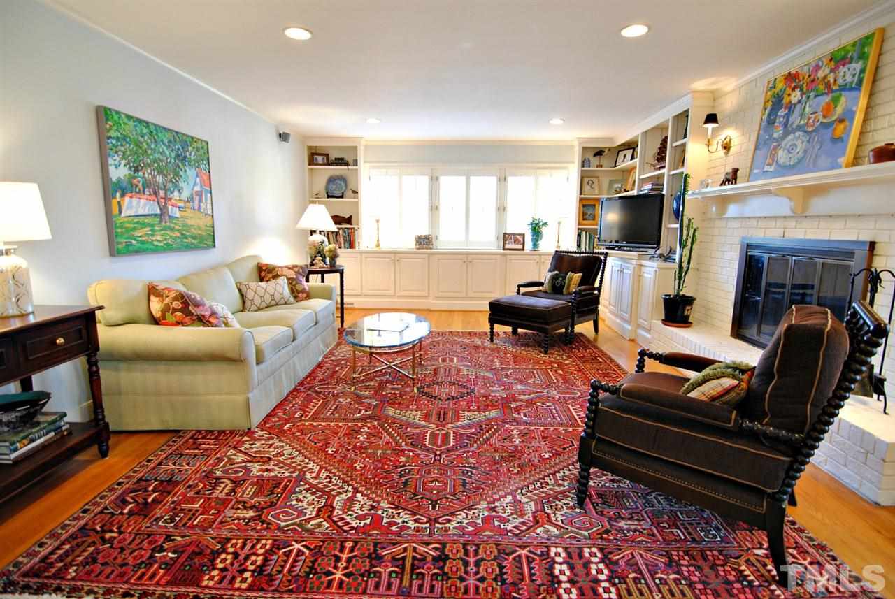 304 Foxhall Street Raleigh, NC 27609 - Photo 8 of 25 a living room with furniture fireplace and a large window