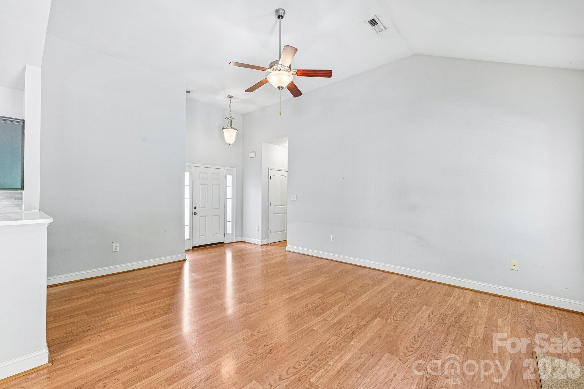 624 Hunley Street Monroe, NC 28112 - Photo 7 of 36 a view of a room with wooden floor and white walls