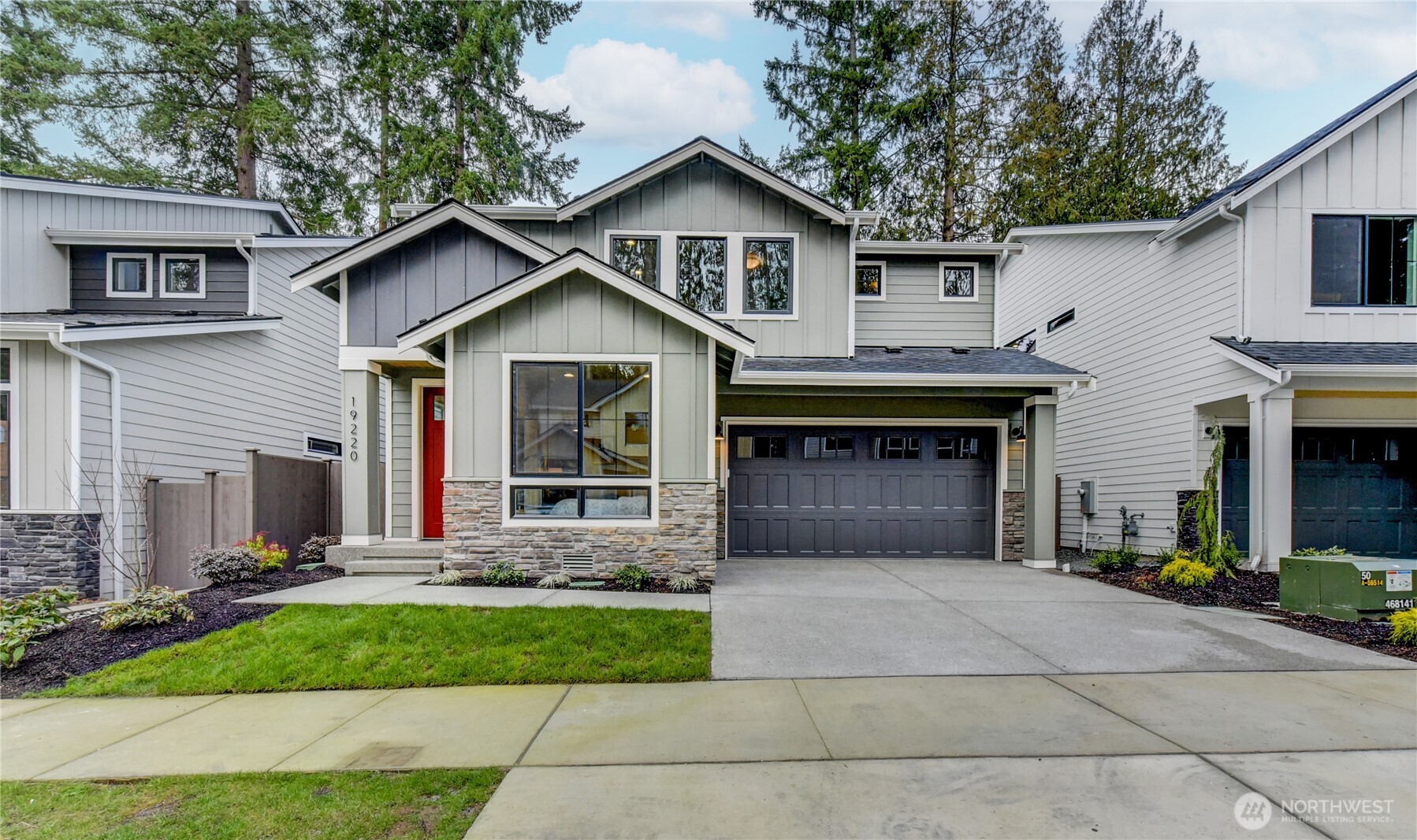 19220 Meridian Drive Southeast, Unit CW 08 Bothell, WA 98012 - Photo 2 of 33 a front view of a house with a yard and garage