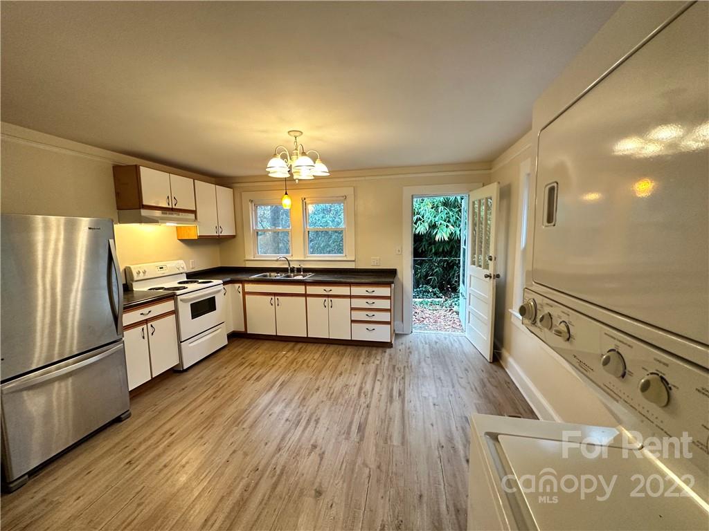 a kitchen with granite countertop a stove and a refrigerator