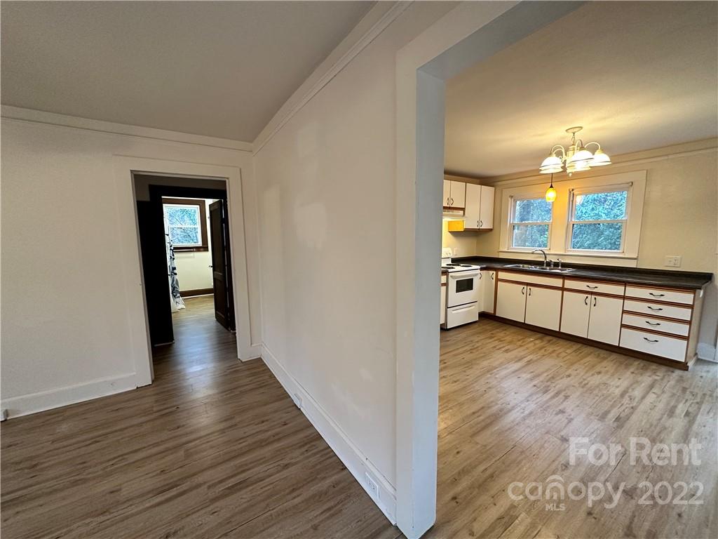 133 Lockhart Road Tryon, NC 28782 - Photo 5 of 17 a view of a kitchen with a sink wooden floor and a kitchen