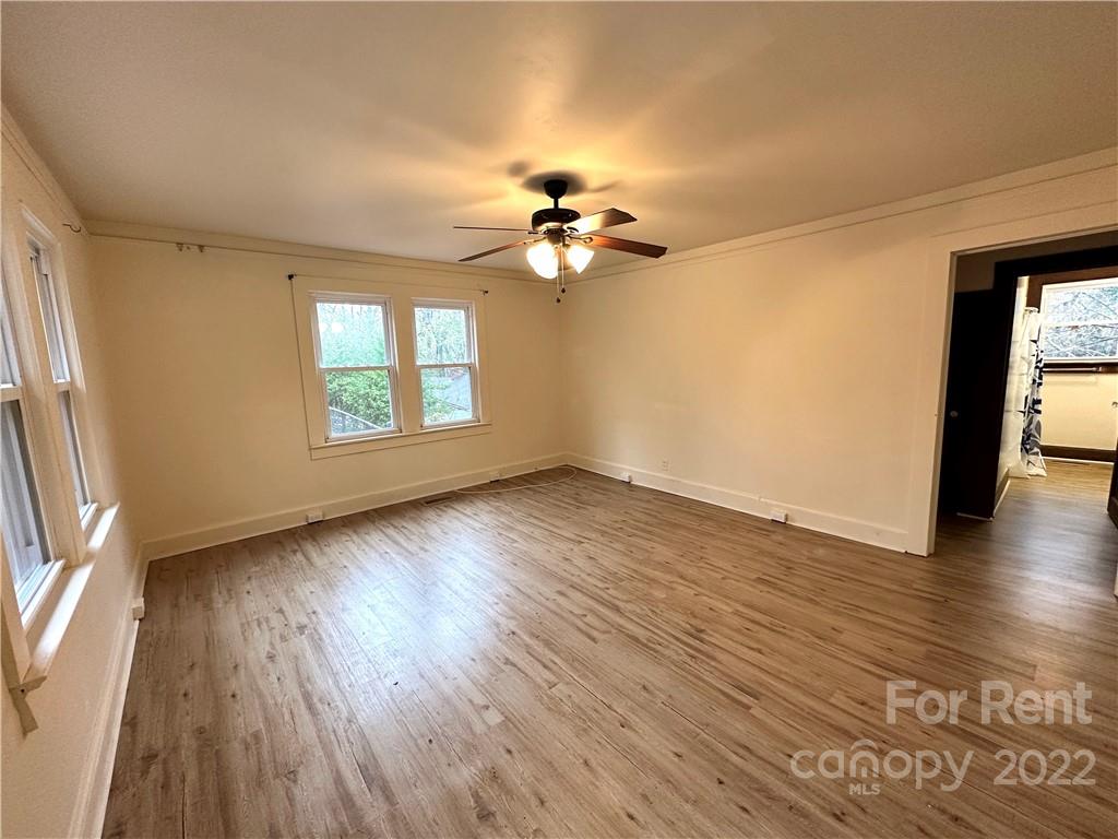 133 Lockhart Road Tryon, NC 28782 - Photo 6 of 17 an empty room with wooden floor and windows