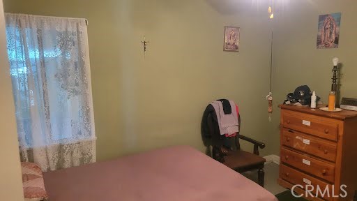 10471 Haddon Avenue Pacoima, CA 91331 - Photo 11 of 23 a bedroom with a bed and a table in it