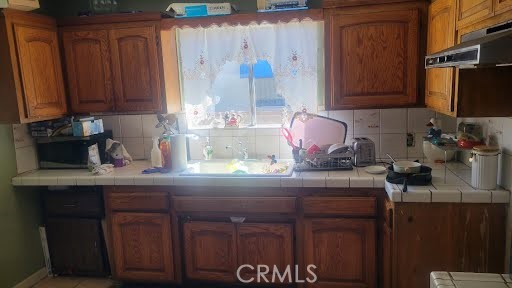 10471 Haddon Avenue Pacoima, CA 91331 - Photo 18 of 23 a kitchen with a sink and cabinets