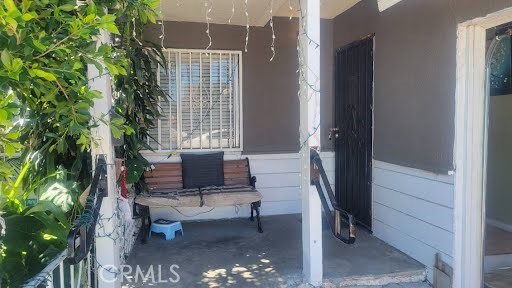 10471 Haddon Avenue Pacoima, CA 91331 - Photo 7 of 23 a living room with furniture and a potted plant