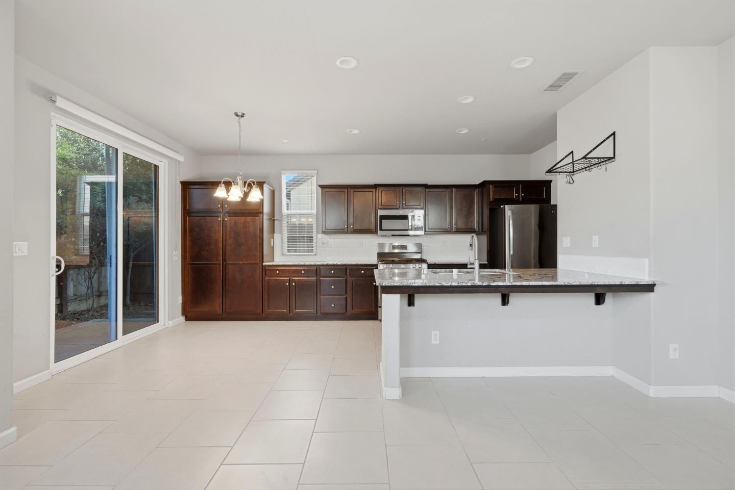 1515 Zenith Clovis, CA 93619 - Photo 12 of 41 a large kitchen with cabinets and a sink