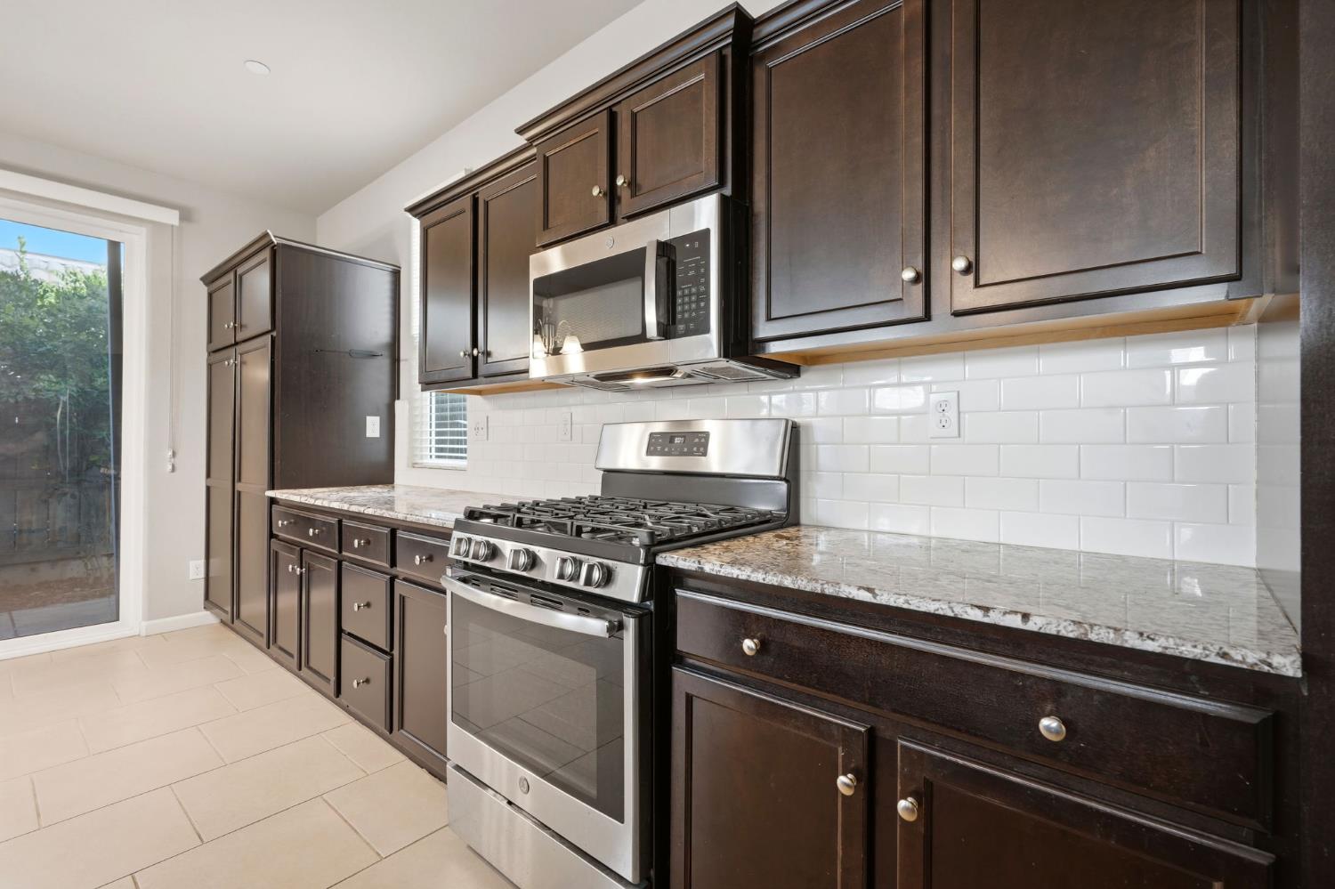 1515 Zenith Clovis, CA 93619 - Photo 15 of 41 a kitchen with stainless steel appliances granite countertop a sink stove and microwave
