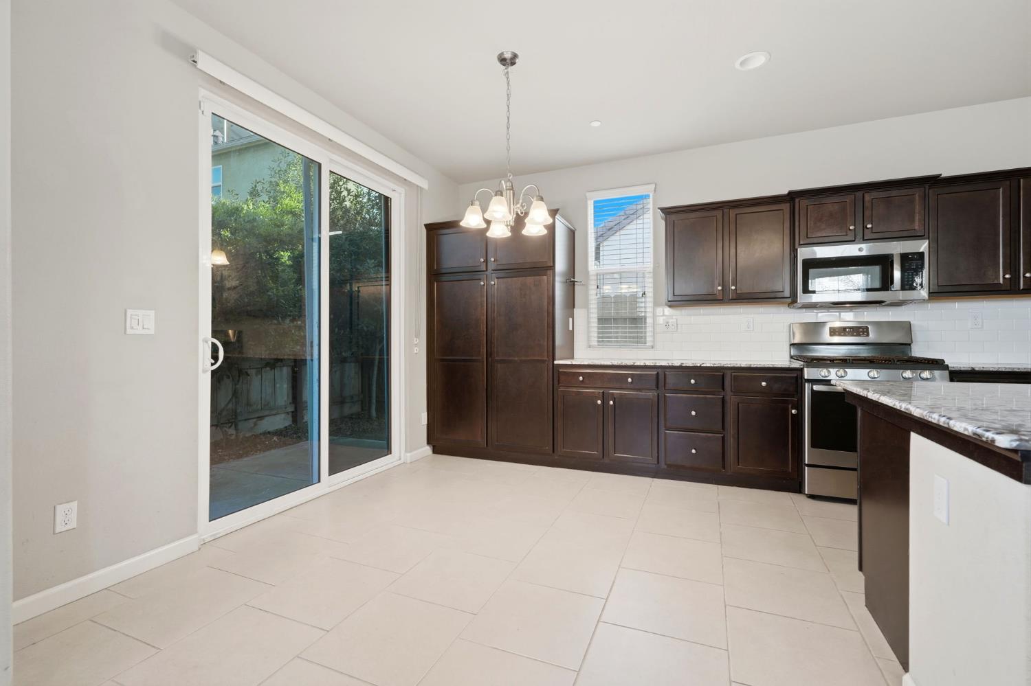 1515 Zenith Clovis, CA 93619 - Photo 18 of 41 a kitchen with stainless steel appliances granite countertop a refrigerator and a sink