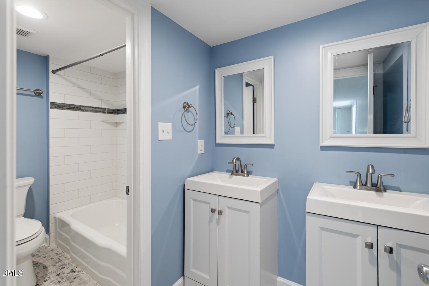 217 Moline Street Durham, NC 27707 - Photo 11 of 30 a bathroom with a sink a toilet and shower